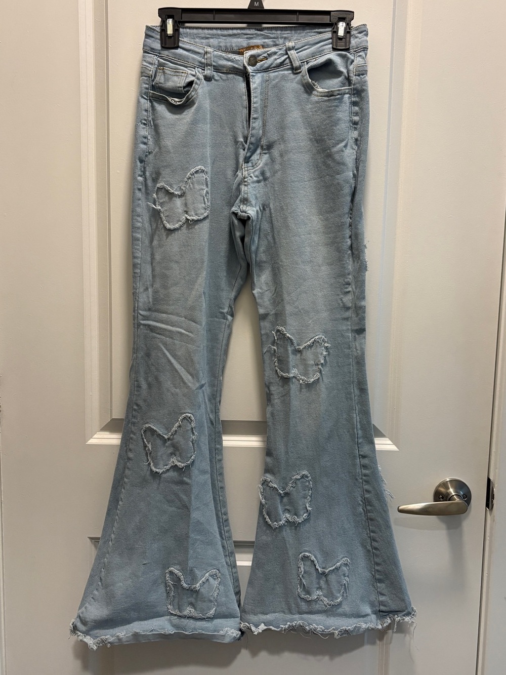 Light Blue Wide-Leg Flare Jeans with Distressed Butterfly Details
